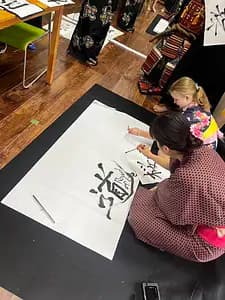 Learning Japanese Zen Calligraphy in Kimono by Osaka Castle