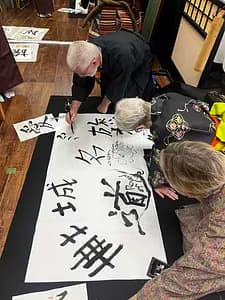 Learning Japanese Zen Calligraphy in Kimono by Osaka Castle
