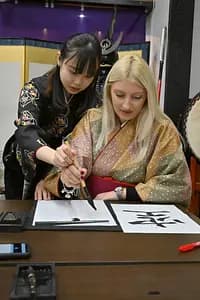 Learning Japanese Zen Calligraphy in Kimono by Osaka Castle