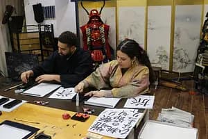 Learning Japanese Zen Calligraphy in Kimono by Osaka Castle