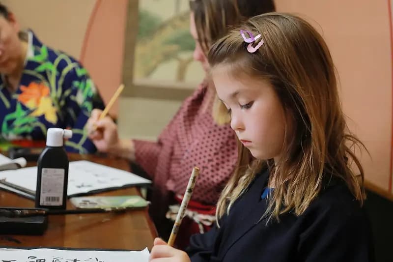 Learning Japanese Zen Calligraphy in Kimono by Osaka Castle